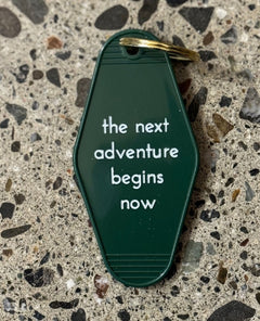 The Next Adventure Begins Now Keychain - miamidrugpossession